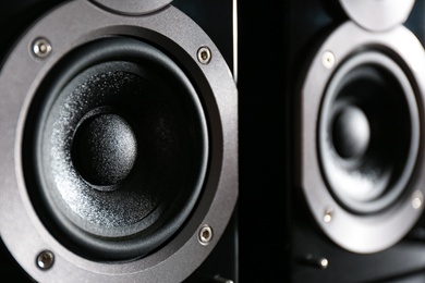 Photo of Modern powerful audio speakers as background, closeup