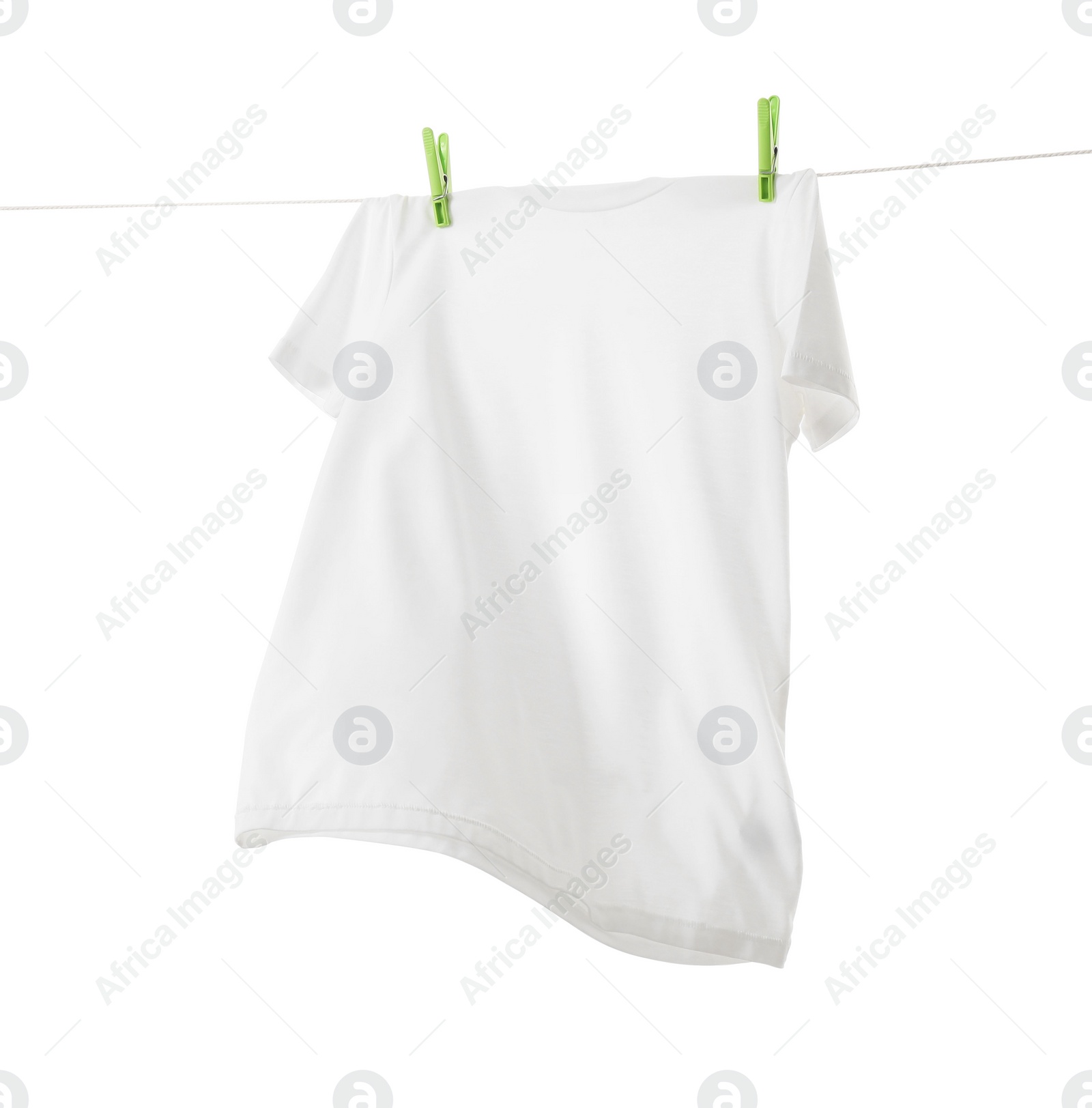 Photo of One t-shirt drying on washing line isolated on white