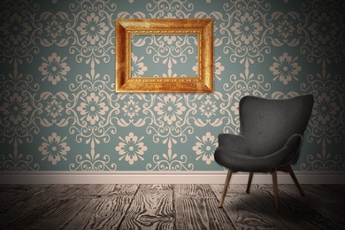Image of Armchair near wall with wooden frame and patterned wallpaper. Stylish room interior