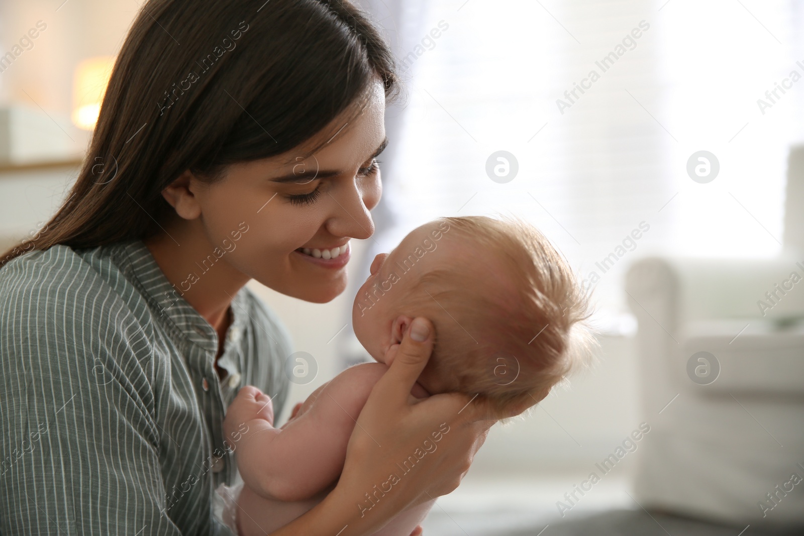 Photo of Mother with her newborn baby at home