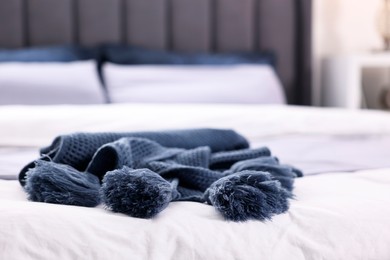 Soft blue plaid on bed in room, closeup