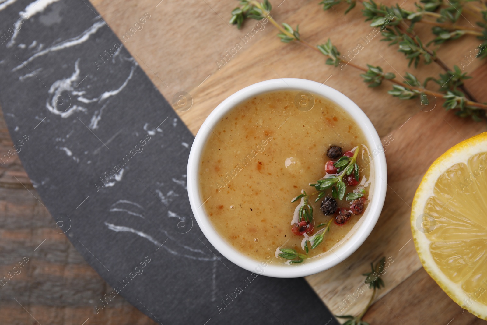 Photo of Delicious turkey gravy, thyme and peppercorns on table, top view