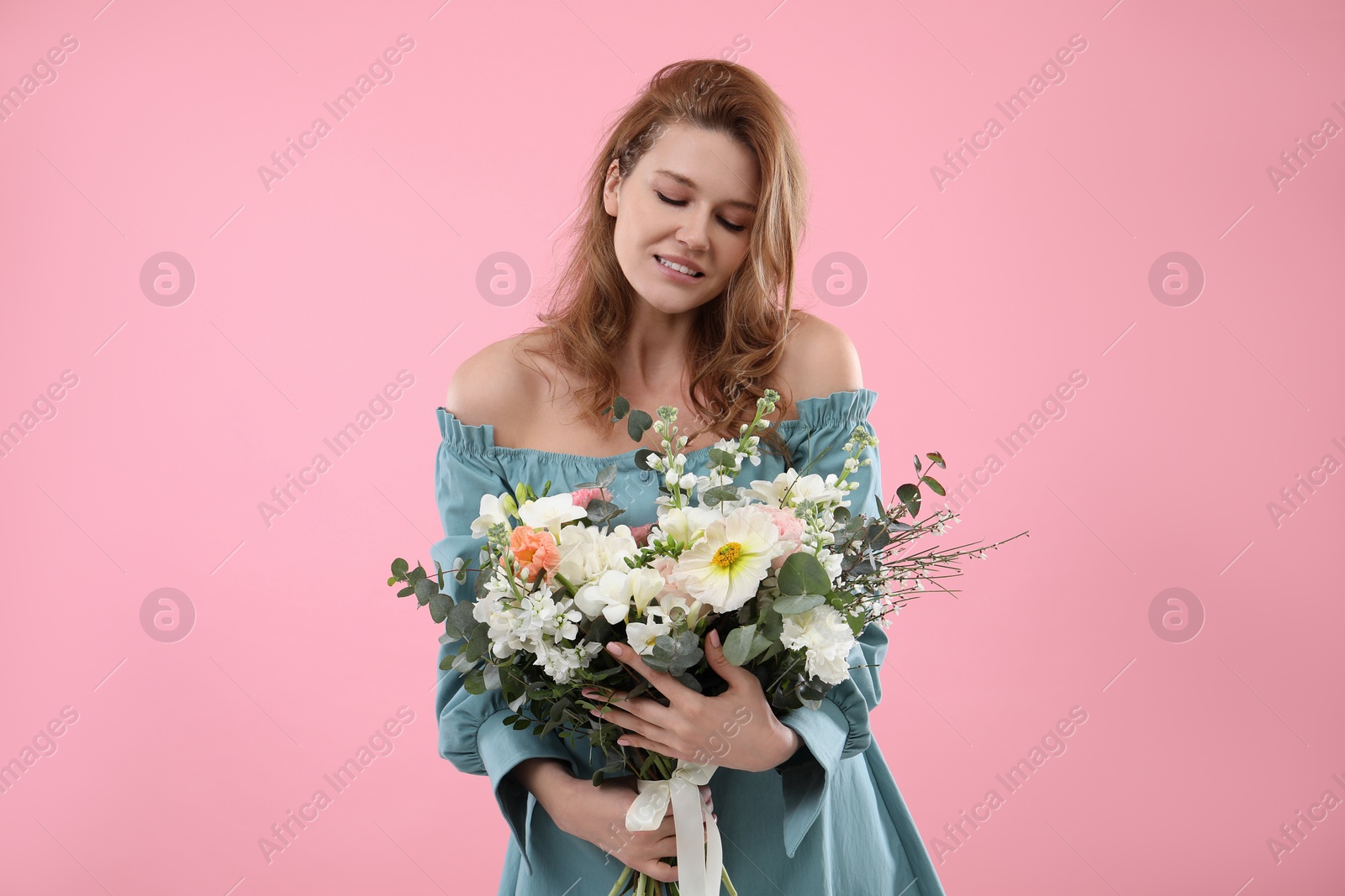 Photo of Beautiful woman with bouquet of flowers on pink background