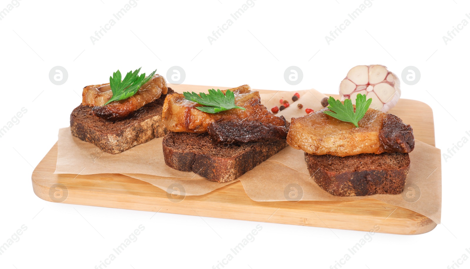 Photo of Rye bread with tasty fried cracklings and parsley on white background. Cooked pork lard