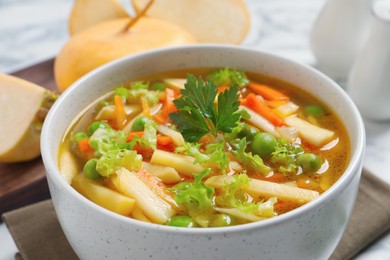 Photo of Bowl of delicious turnip soup, closeup view