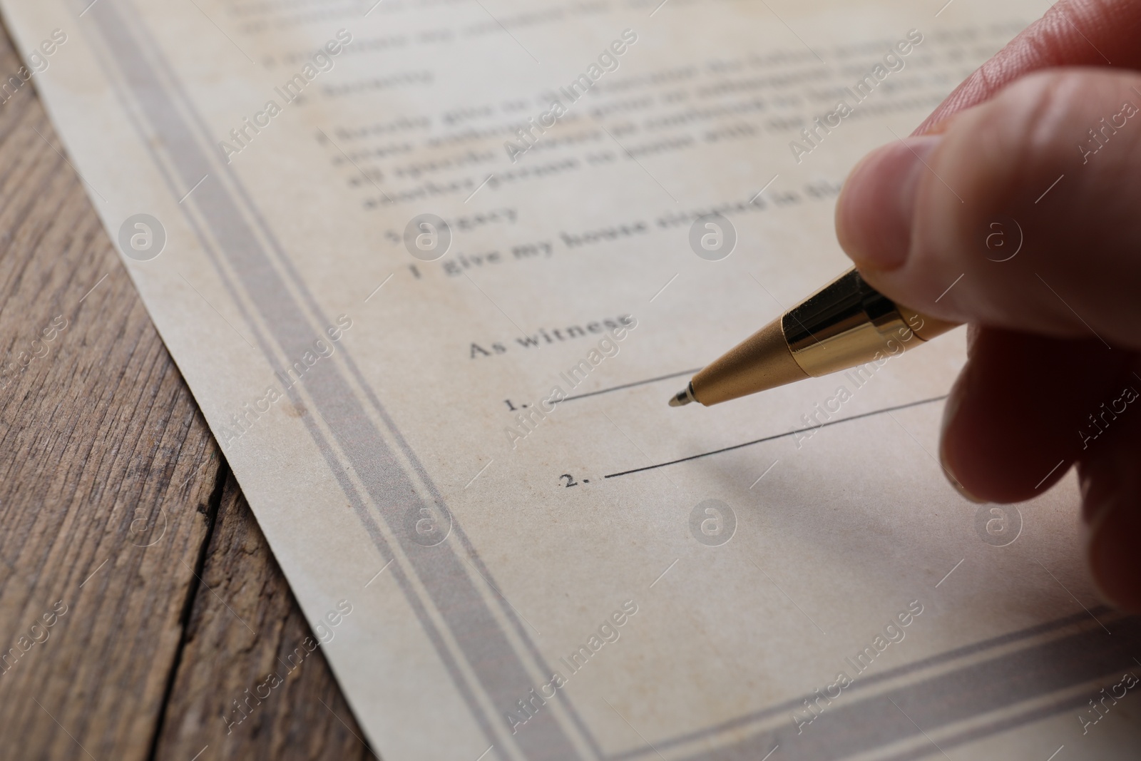 Photo of Woman signing Last Will and Testament at wooden table, closeup