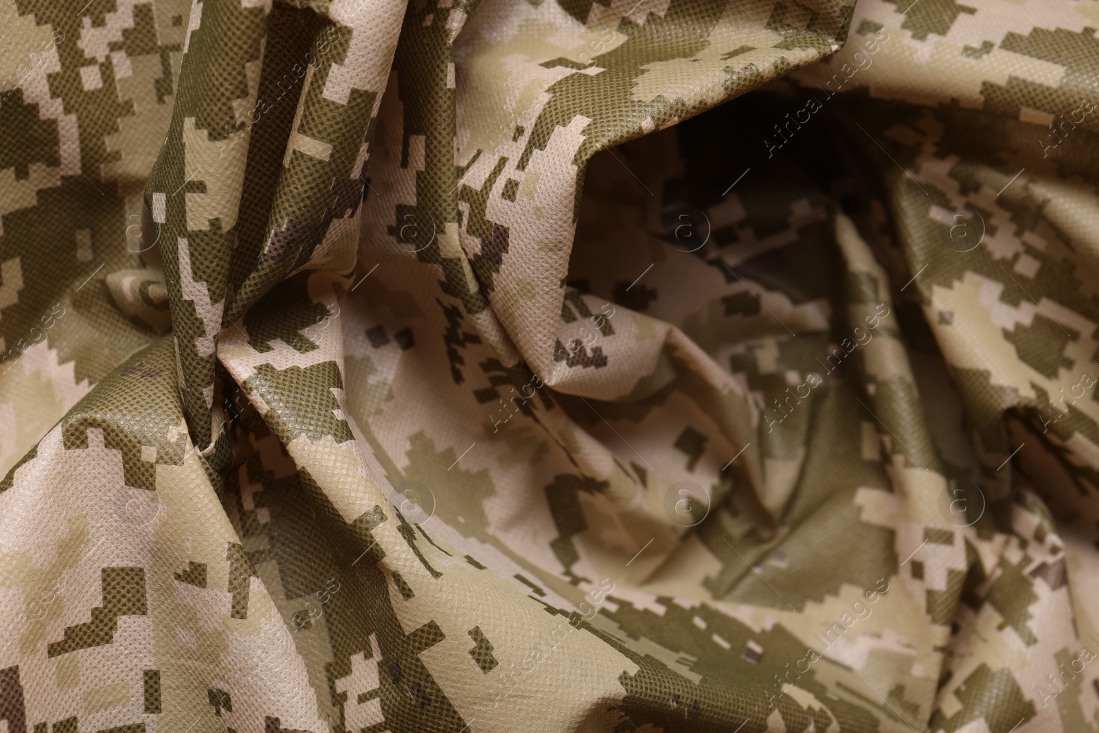 Photo of Texture of crumpled camouflage fabric as background, closeup