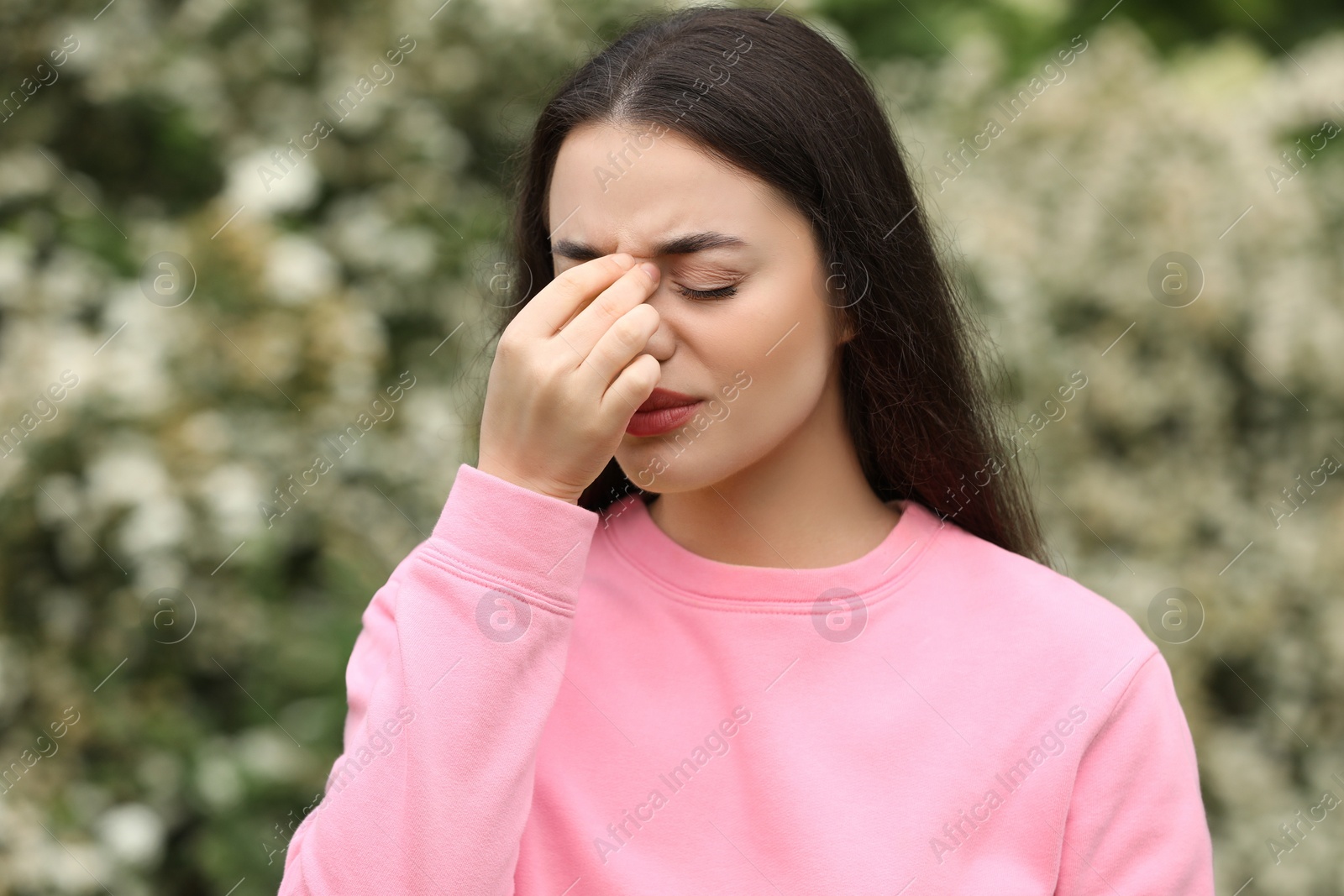 Photo of Woman suffering from seasonal spring allergy outdoors