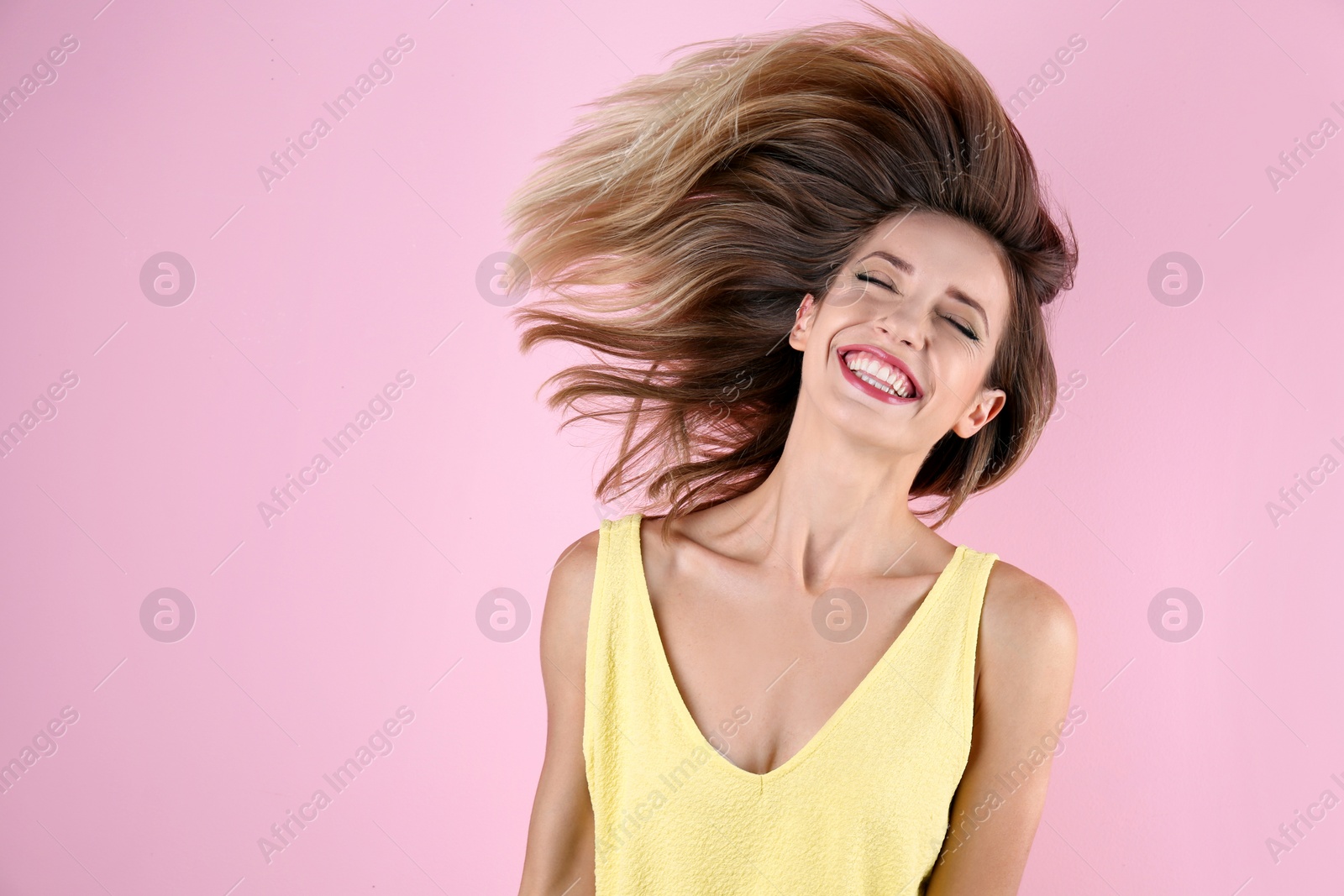 Photo of Portrait of beautiful laughing woman on color background