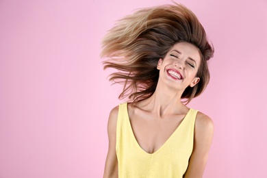 Photo of Portrait of beautiful laughing woman on color background