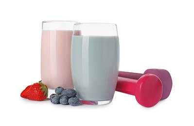 Photo of Tasty shakes, strawberries, blueberries and dumbbells isolated on white. Weight loss
