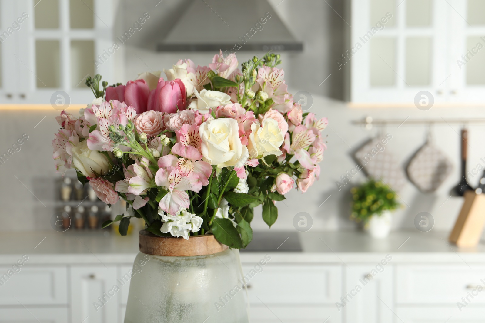 Photo of Beautiful bouquet of fresh flowers in vase indoors