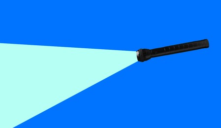 Flashlight illuminating blue background. Light symbolizing search, guidance, direction and other