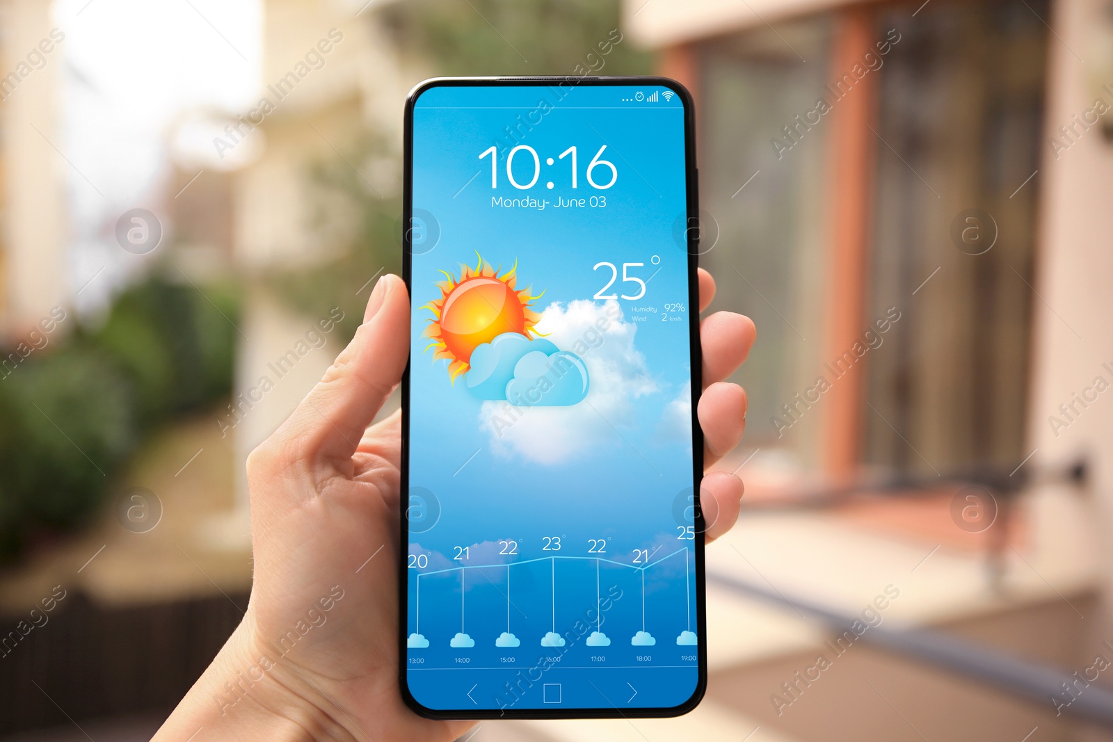Image of Woman checking weather using app on smartphone outdoors, closeup. Data and illustration of sun with cloud on screen