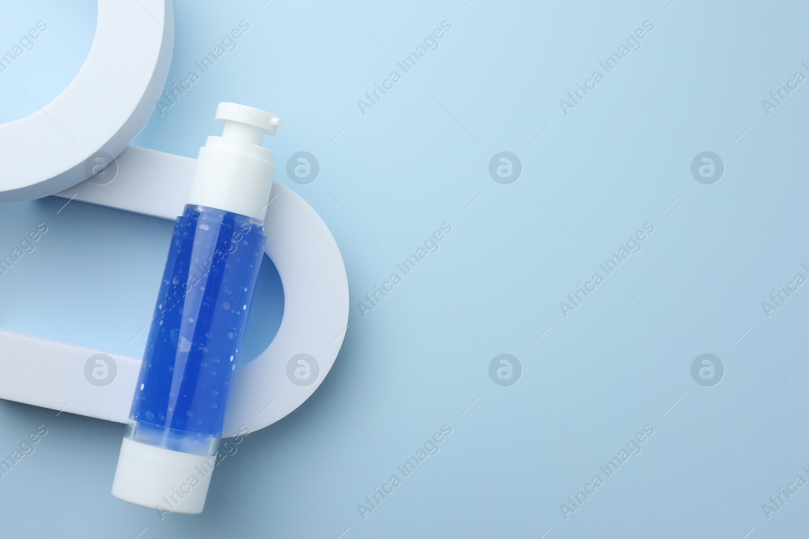 Photo of Cosmetic product on light blue background, top view. Space for text