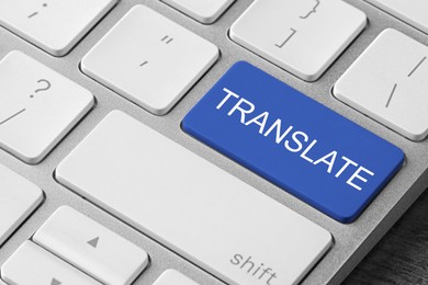 Image of Blue button with word TRANSLATE on computer keyboard, closeup view