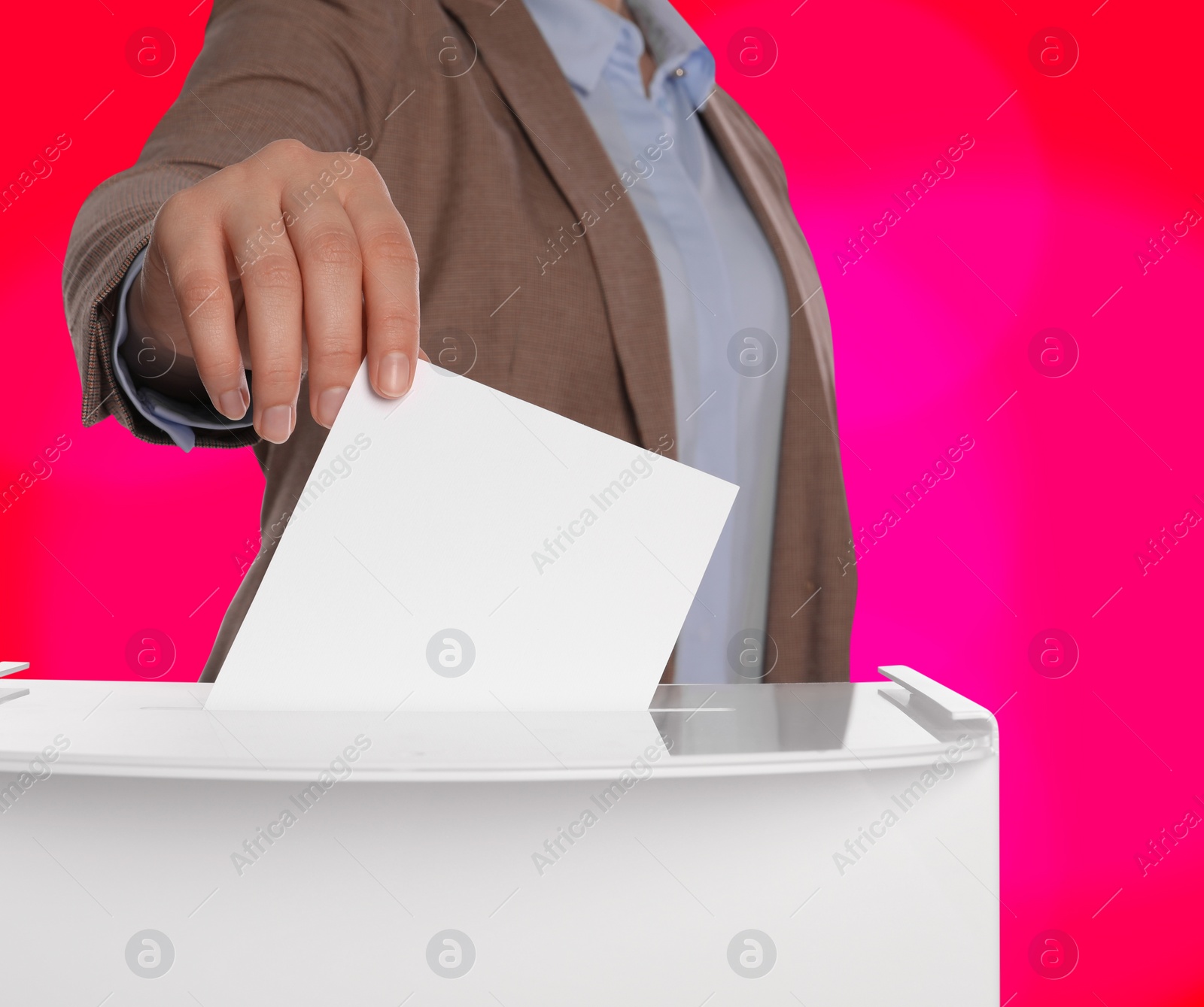 Image of Woman putting her vote into ballot box on color background, closeup
