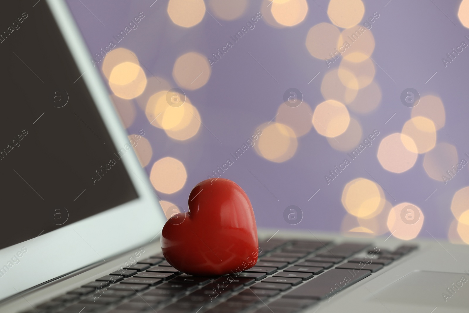 Photo of Red decorative heart on laptop, closeup view. Online dating