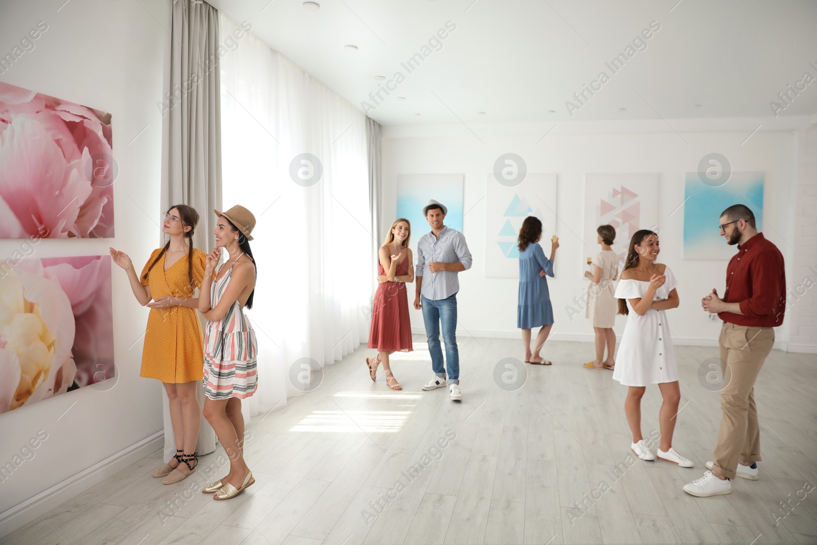 Photo of Group of people at exhibition in art gallery