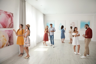 Group of people at exhibition in art gallery