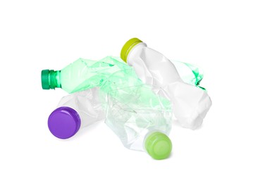 Pile of different plastic bottles on white background