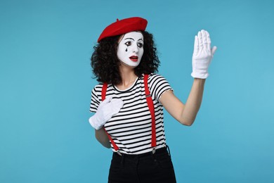 Photo of Funny mine with beret posing on light blue background
