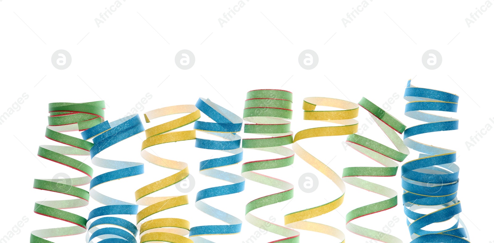 Photo of Bright serpentine streamers on white background. Festive decor