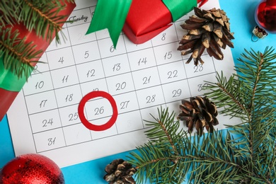 Photo of Flat lay composition with calendar and gifts on light blue background. Boxing day