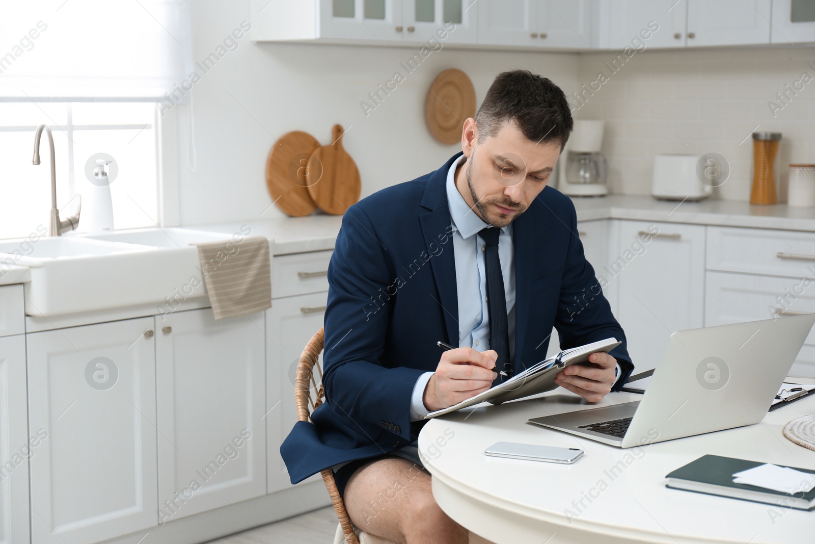 Photo of Businessman in underwear pretending to wear formal clothes during video call at home