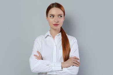 Portrait of beautiful young woman on light gray background