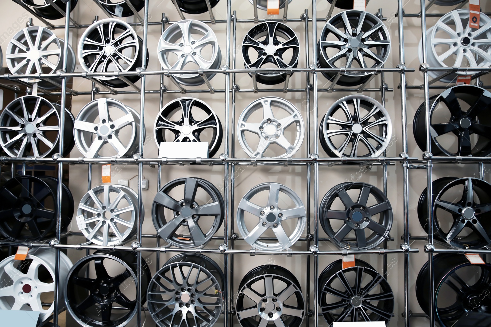 Photo of Alloy wheels on racks in automobile service center
