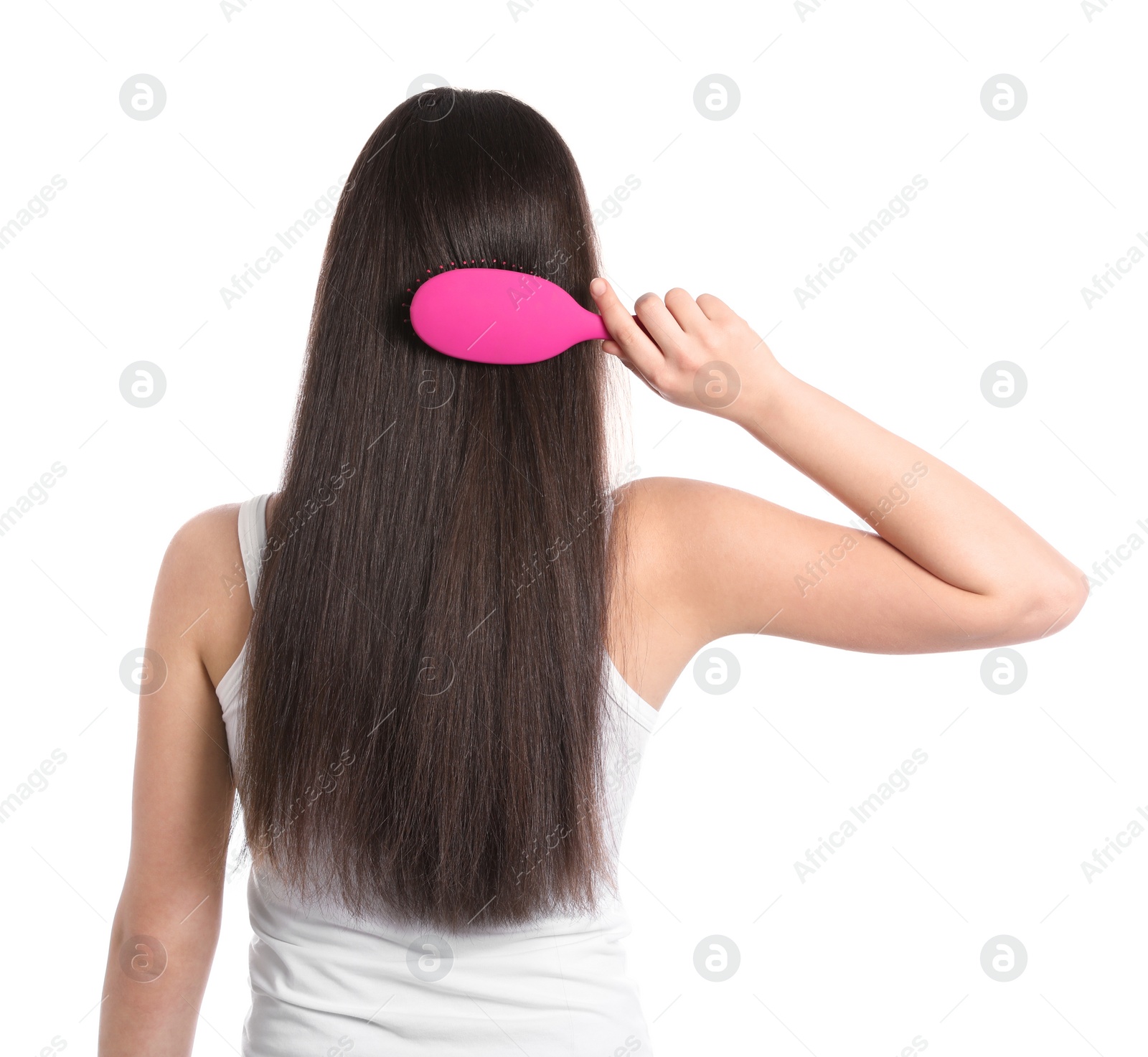 Photo of Back view of young woman with hair brush on white background