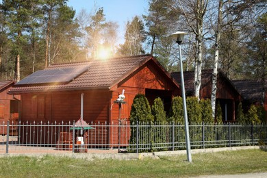 House with installed solar panels on roof. Alternative energy