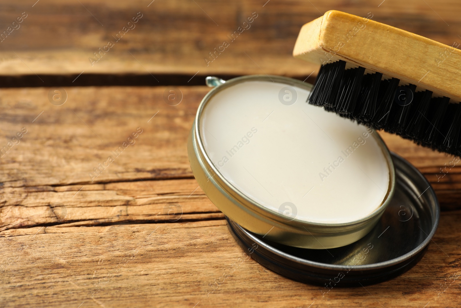 Photo of Shoe care accessories on wooden background, closeup. Space for text