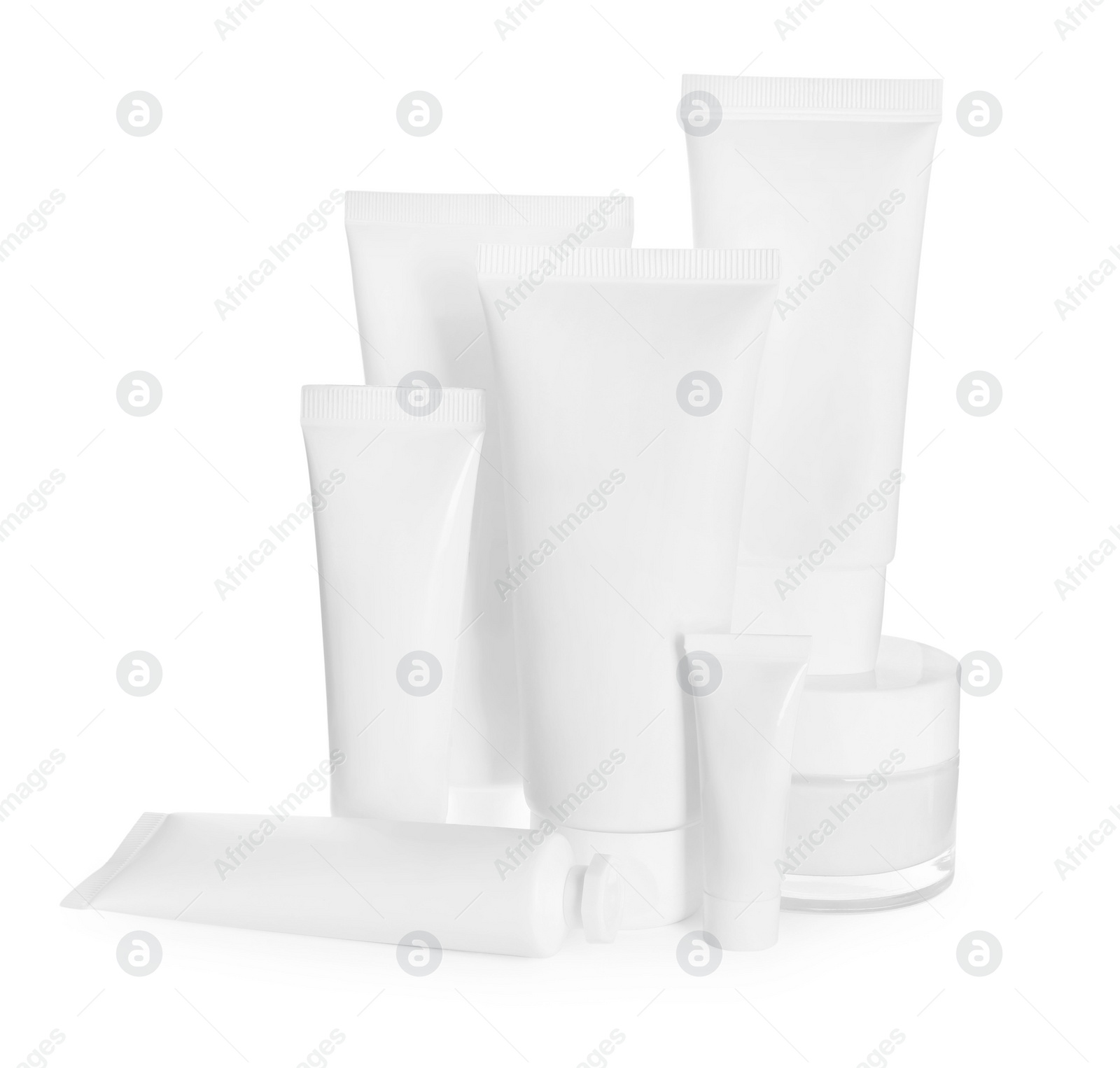 Photo of Blank tubes and jars of cosmetic products on white background