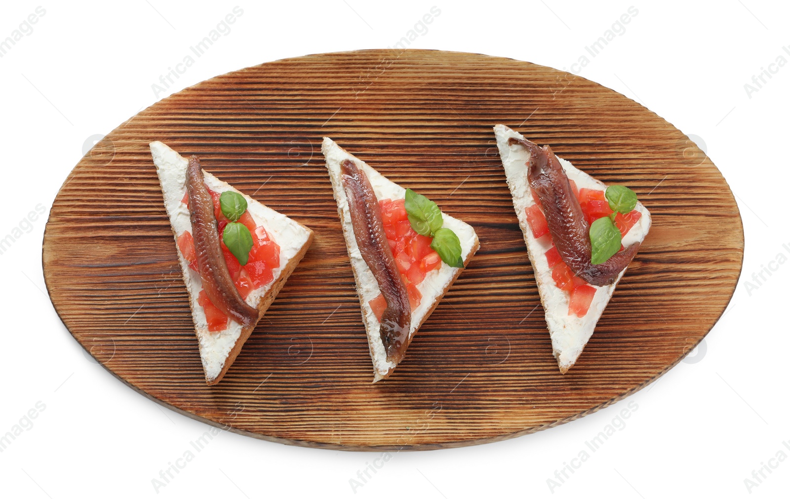 Photo of Delicious sandwiches with cream cheese, anchovies, tomatoes and basil on white background, top view