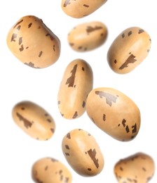 Many beans falling on white background. Vegan diet 