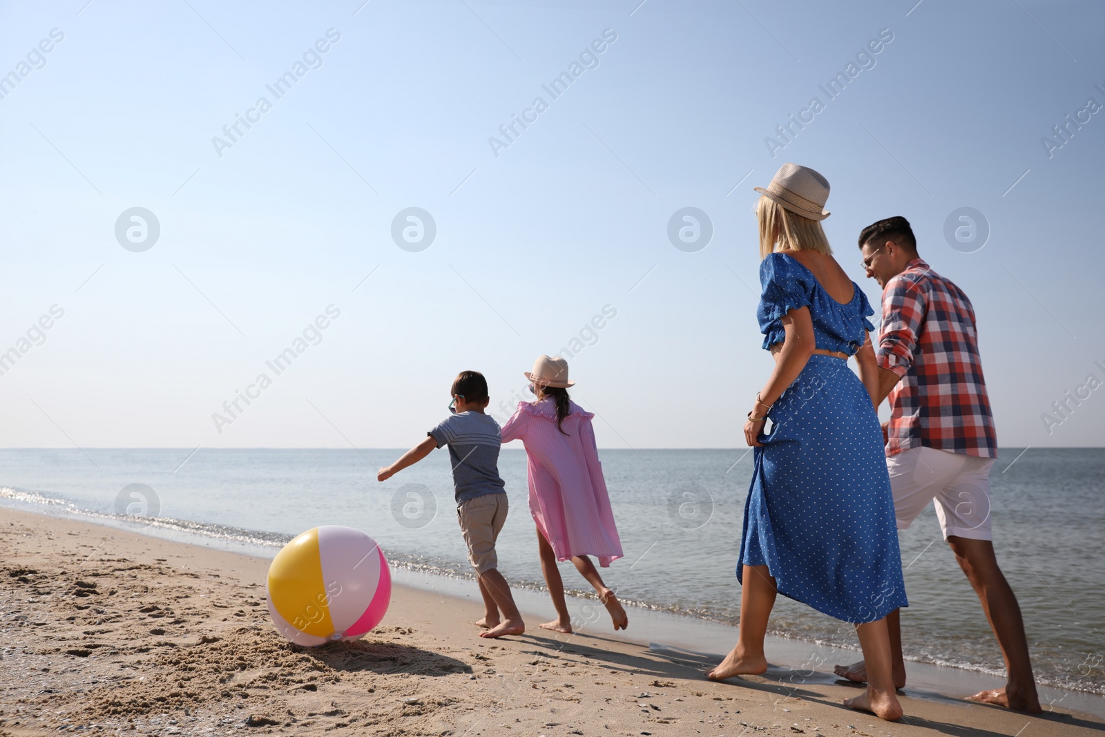 Photo of Happy family at beach on sunny summer day