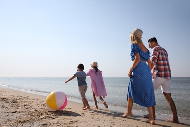 Happy family at beach on sunny summer day