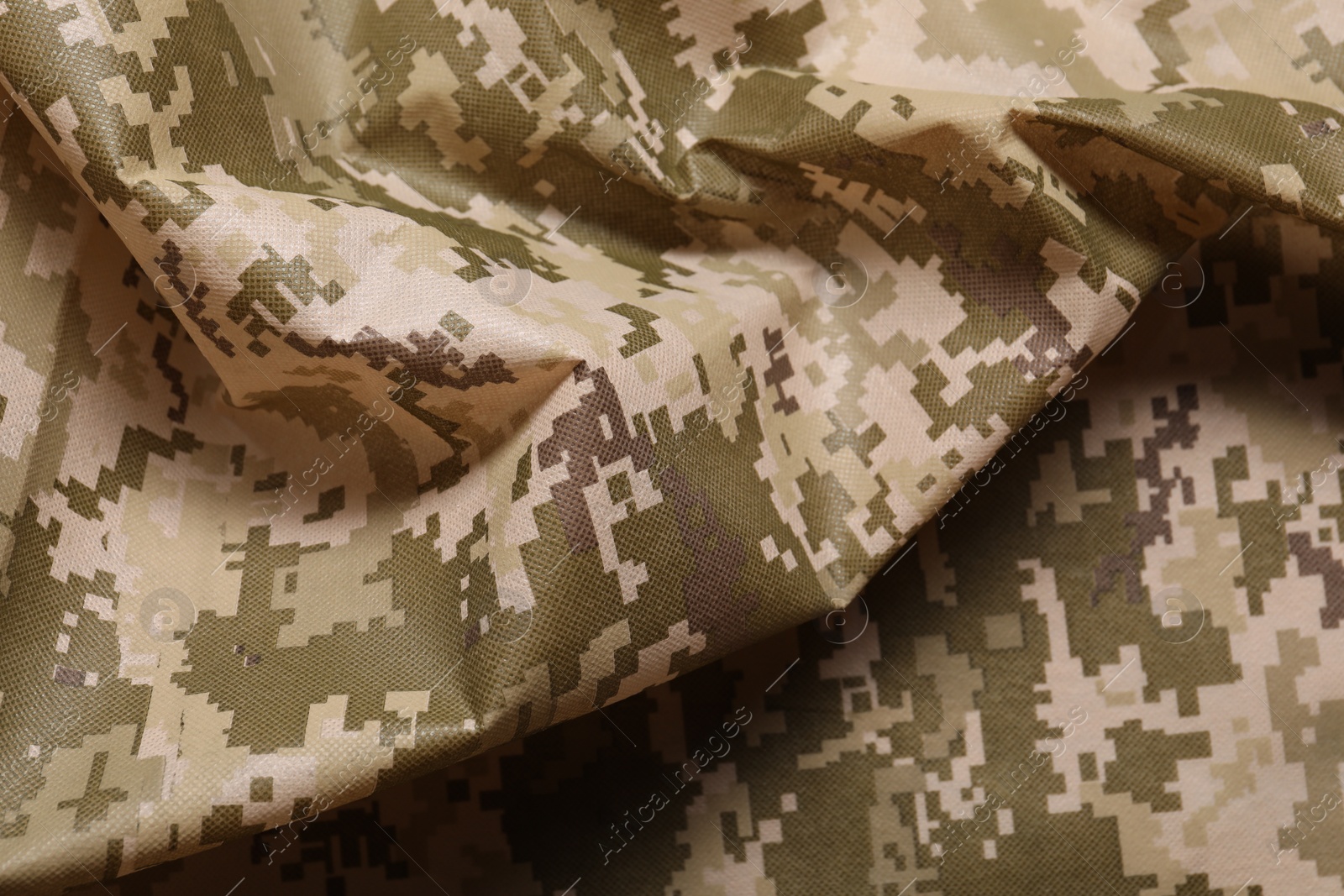 Photo of Texture of crumpled camouflage fabric as background, closeup