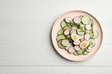 Photo of Tasty fresh salad with cucumber on white wooden table, top view. Space for text