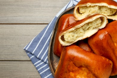 Photo of Delicious baked patties with potato on wooden table, top view. Space for text