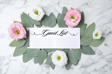 Image of Fresh eucalyptus leaves, flowers and guest list on white marble background, flat lay
