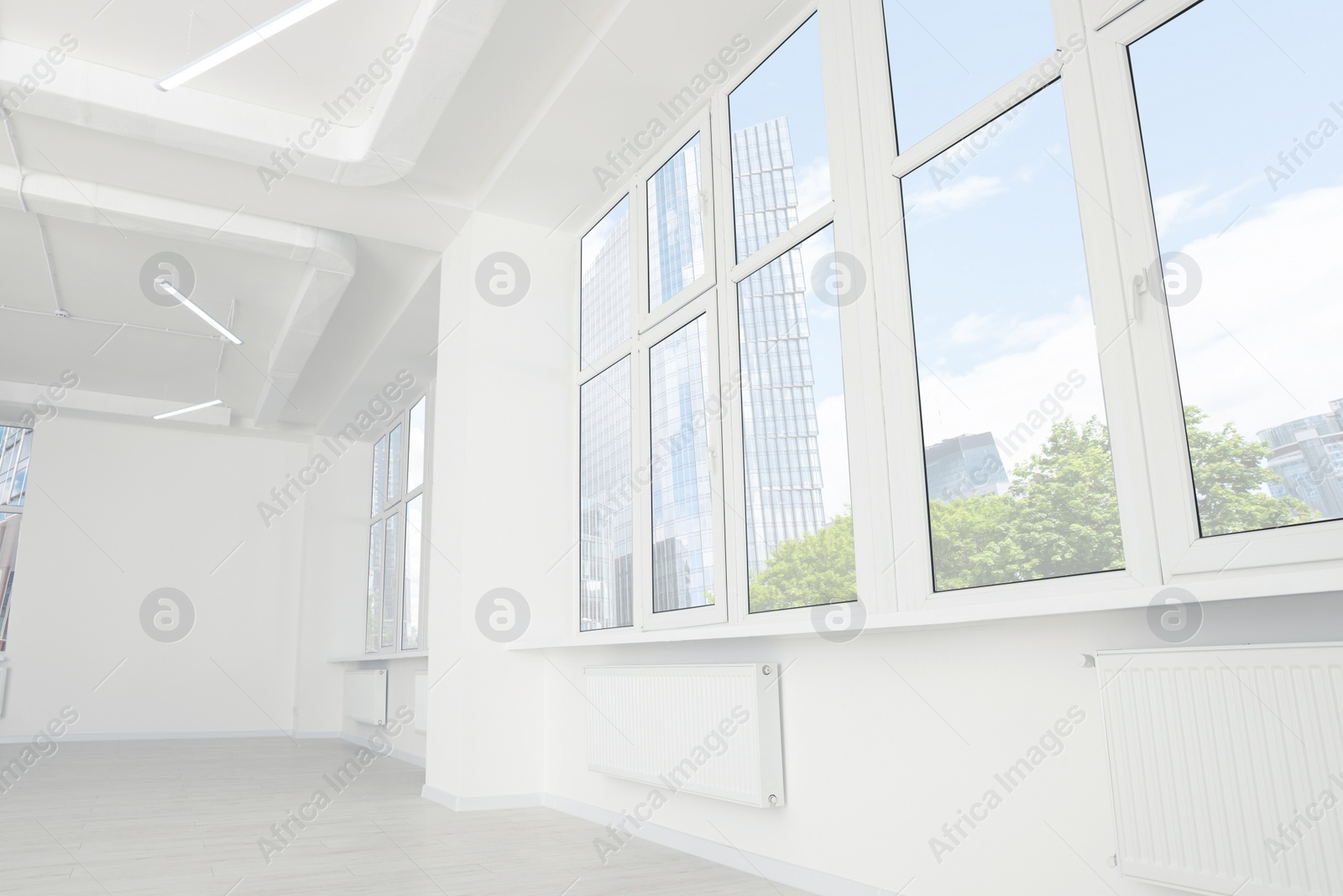 Photo of Modern office room with white walls and windows. Interior design