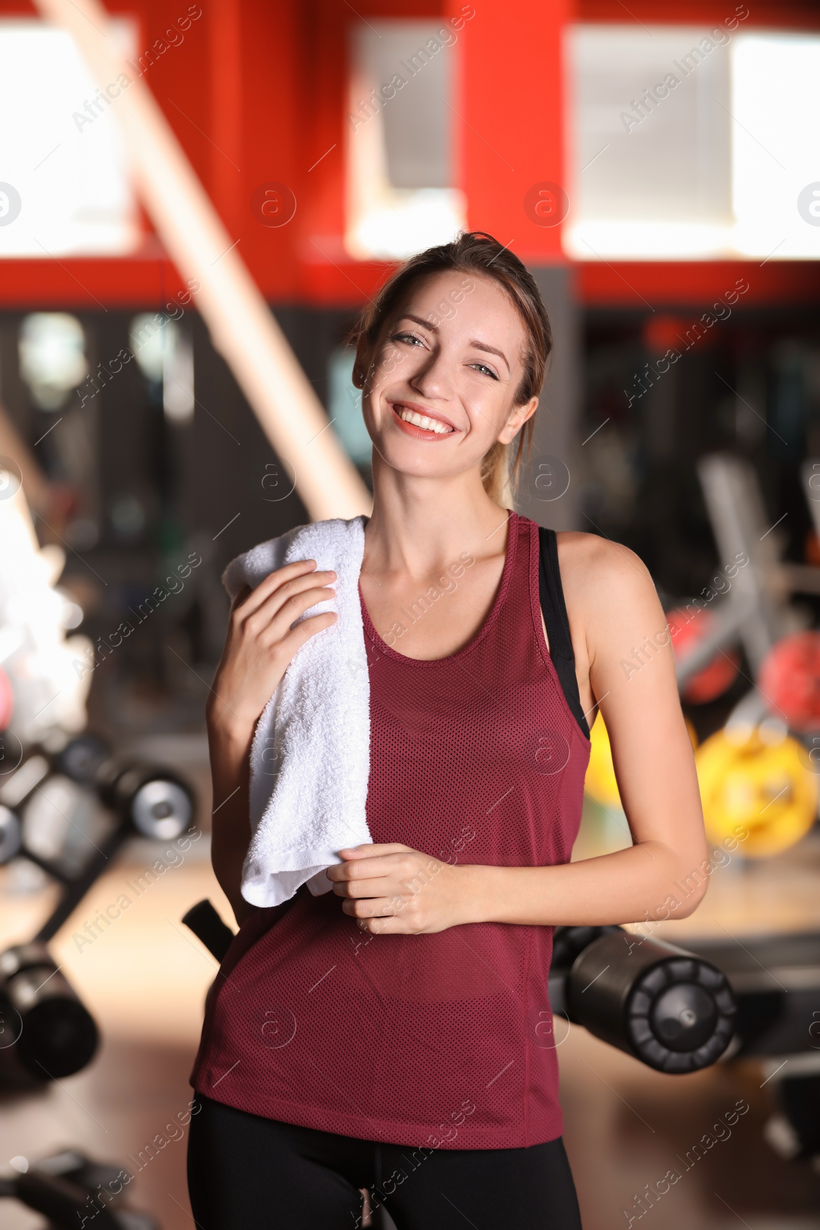 Photo of Beautiful young woman with towel in gym