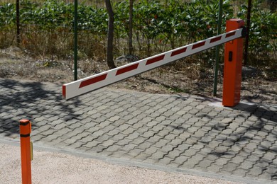 Photo of Closed boom barrier on sunny day outdoors