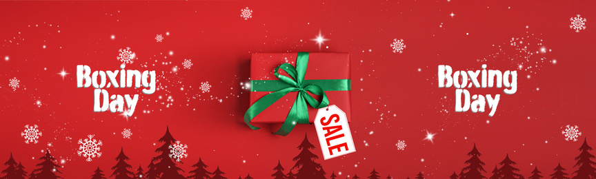 Image of Boxing day banner design. Gift with sale tag on red background