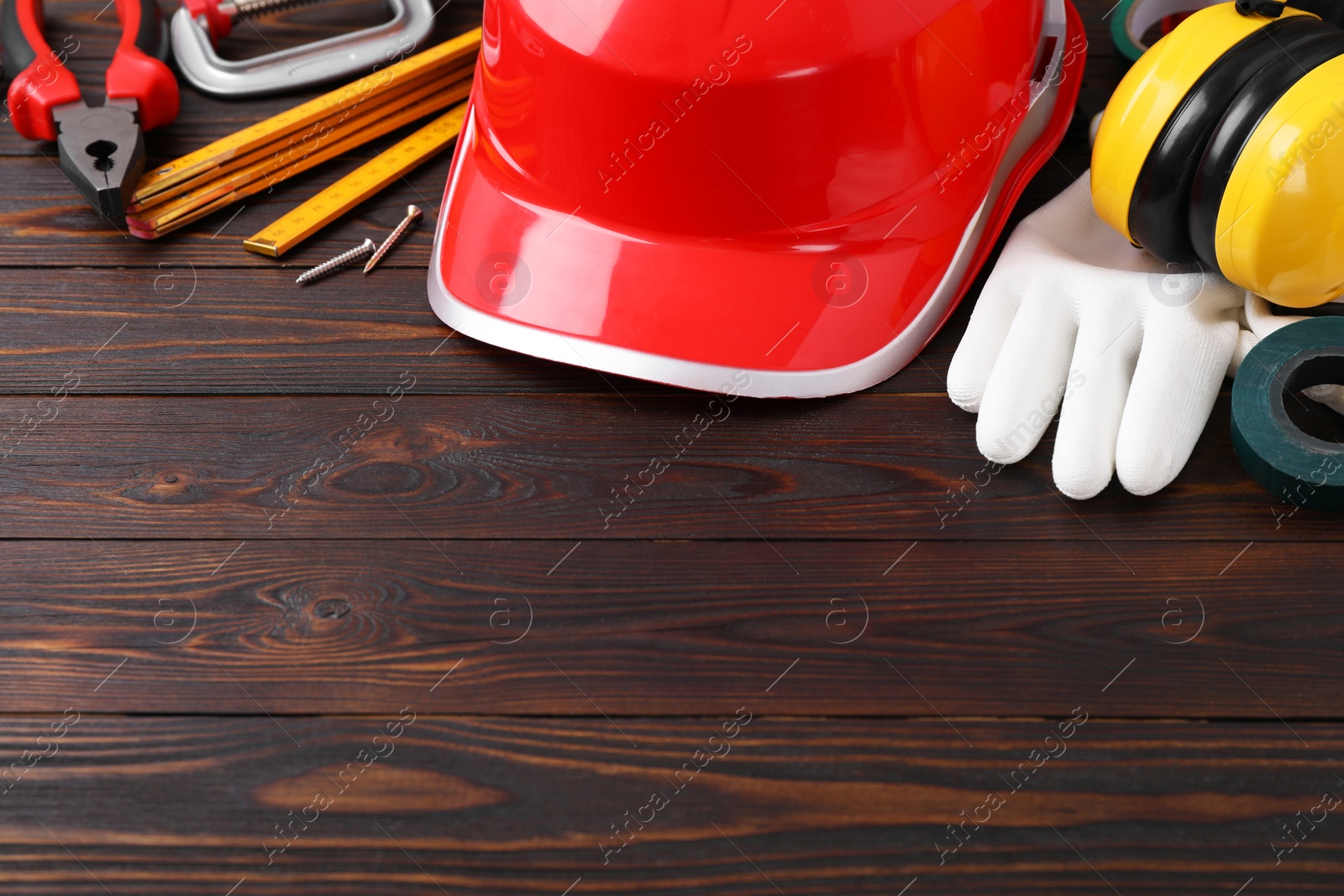 Photo of Different construction tools on wooden background. Space for text