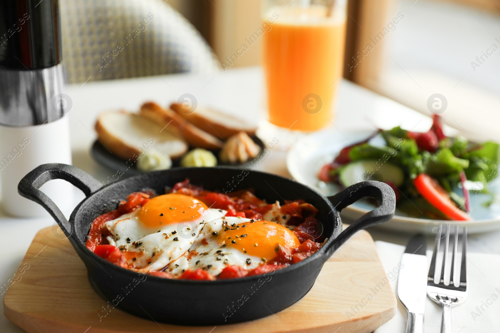 Photo of Tasty Shakshouka served on white table. Traditional Arabic dish