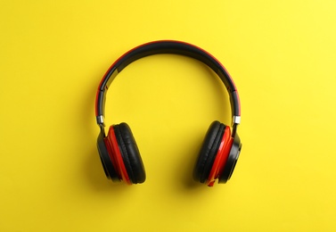 Wireless headphones on color background, top view